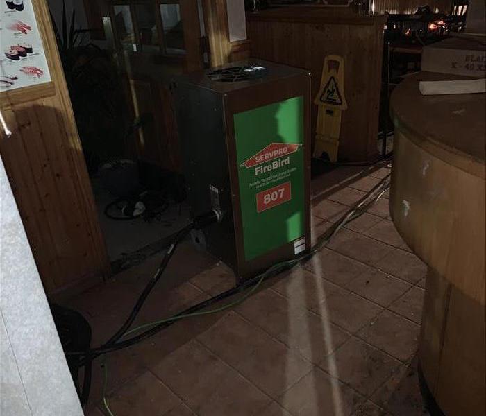Restaurant with fire damage and SERVPRO equipment running