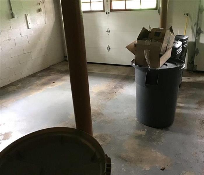 Basement cleaned with trash containers after flood water removal